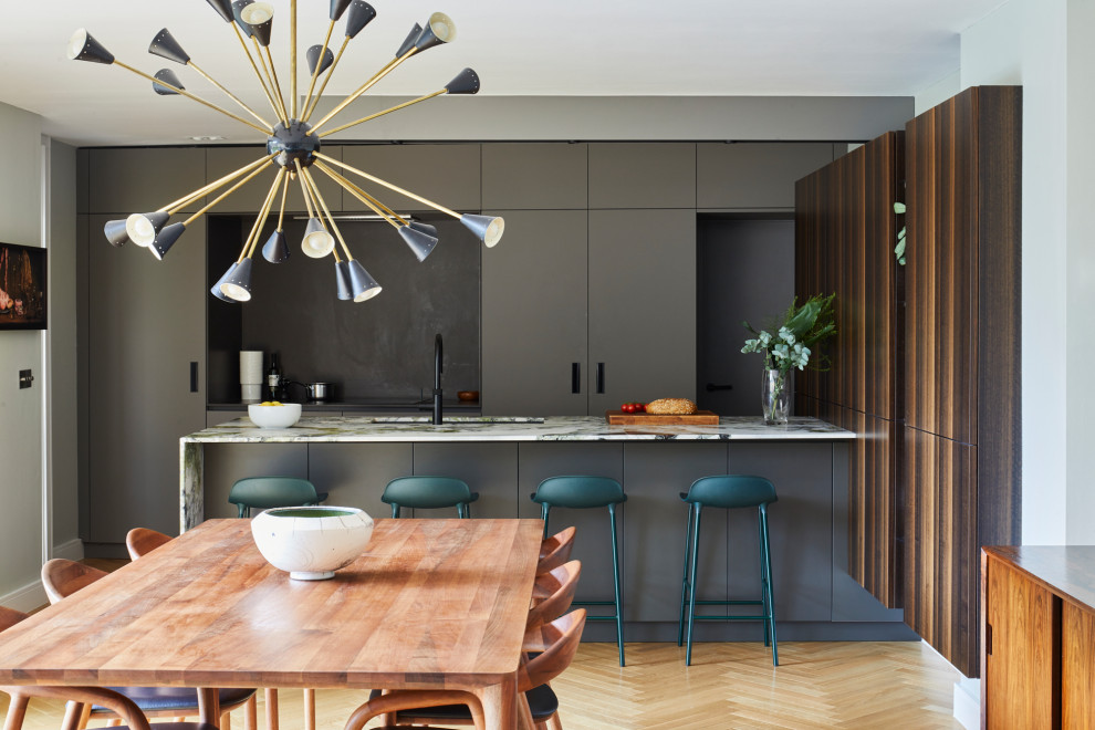 Inspiration for a large contemporary open plan kitchen in London with flat-panel cabinets, grey cabinets, marble worktops, integrated appliances and multicoloured worktops.