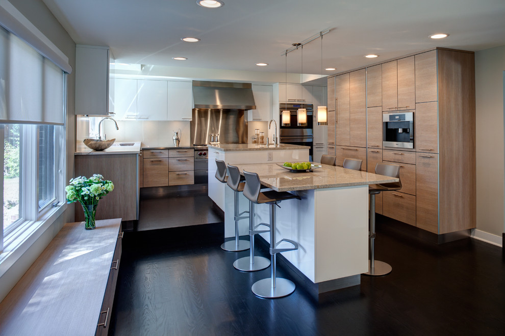 This is an example of a contemporary l-shaped kitchen in Chicago with flat-panel cabinets and light wood cabinets.