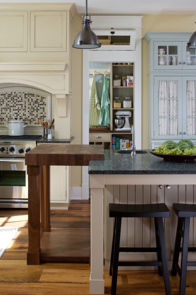 Elegant kitchen photo in Grand Rapids with wood countertops