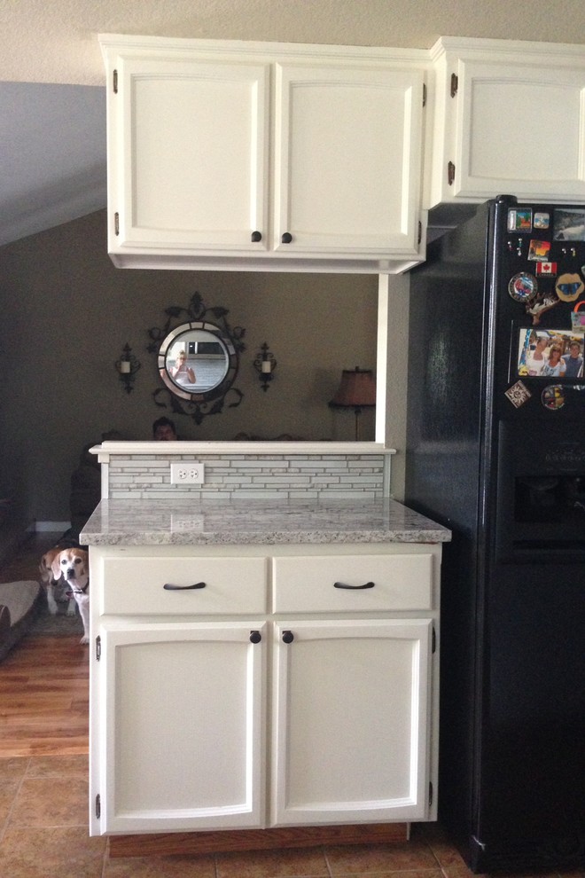 Small beach style u-shaped ceramic tile eat-in kitchen photo in Sacramento with recessed-panel cabinets, white cabinets, granite countertops, gray backsplash, glass sheet backsplash, stainless steel appliances and an undermount sink
