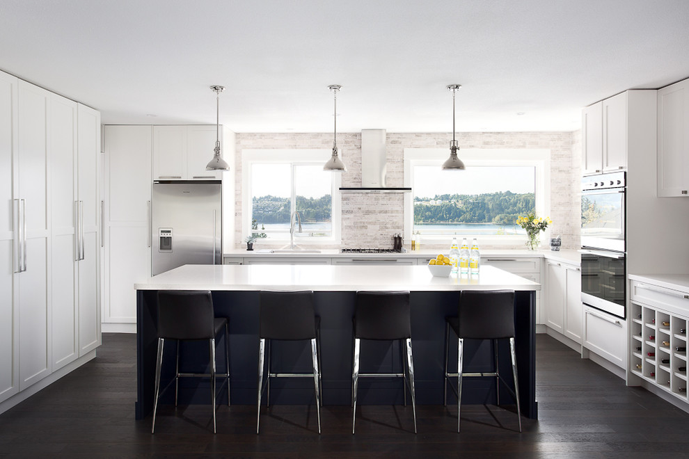 Inspiration for a contemporary u-shaped kitchen in Vancouver with recessed-panel cabinets, white cabinets, grey splashback and stainless steel appliances.