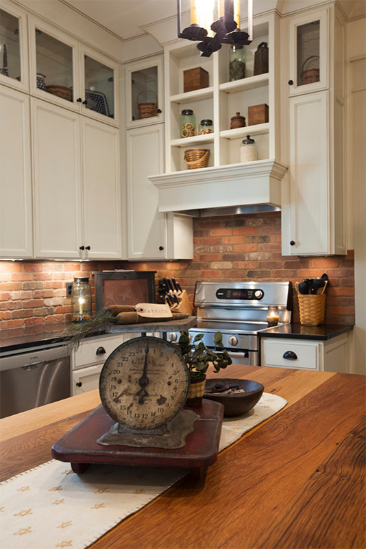 Inspiration for a small craftsman l-shaped eat-in kitchen remodel in Louisville with recessed-panel cabinets, white cabinets, brown backsplash, stainless steel appliances and an island