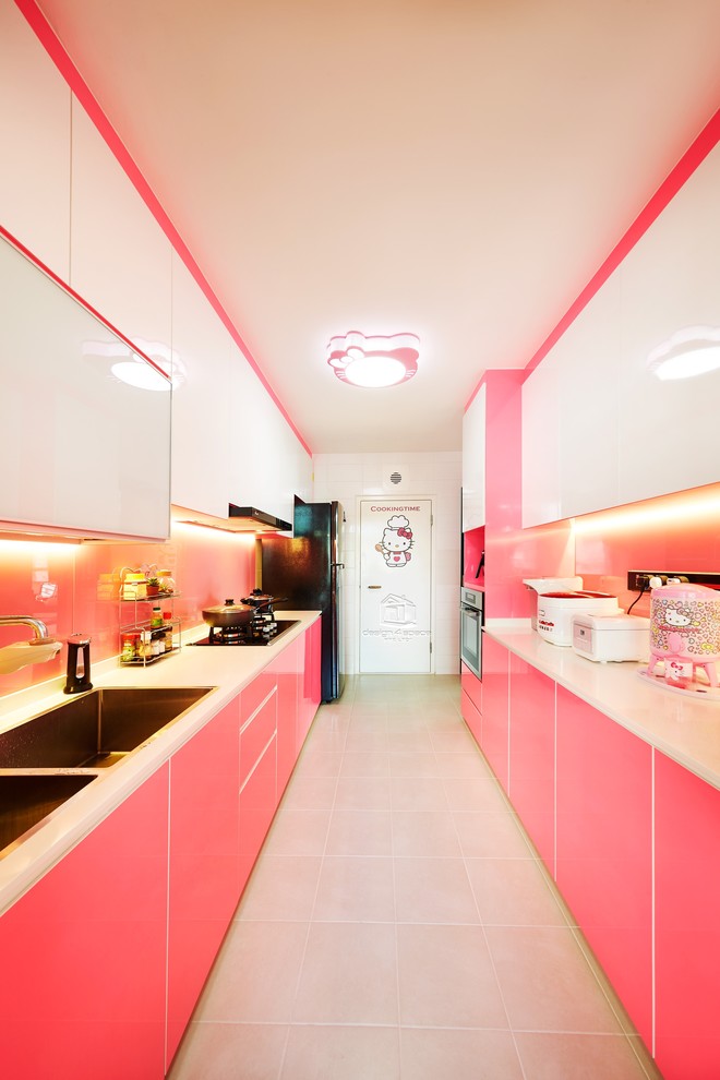 Design ideas for a contemporary galley kitchen in Singapore with a double-bowl sink, flat-panel cabinets, pink splashback, glass sheet splashback, black appliances and no island.