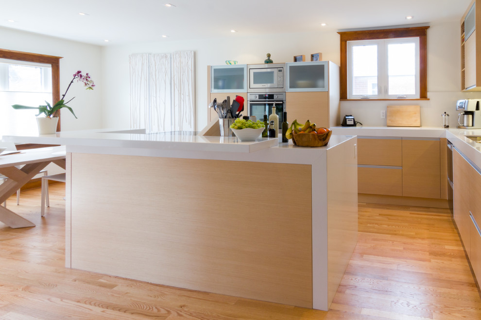 Eat-in kitchen - mid-sized modern l-shaped light wood floor eat-in kitchen idea in Ottawa with flat-panel cabinets, light wood cabinets, quartz countertops, stainless steel appliances and an island