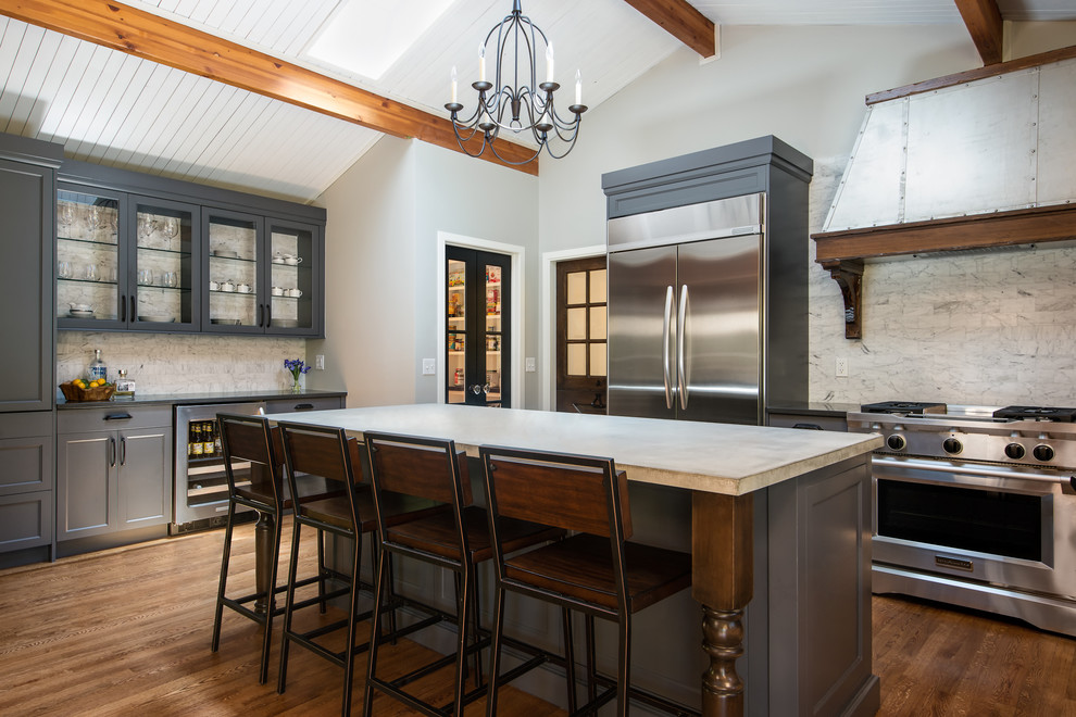 Eat-in kitchen - large transitional u-shaped medium tone wood floor eat-in kitchen idea in Detroit with a farmhouse sink, recessed-panel cabinets, gray cabinets, concrete countertops, multicolored backsplash, stone tile backsplash, stainless steel appliances and an island