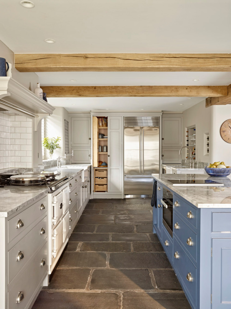 Inspiration for a large farmhouse gray floor eat-in kitchen remodel in Other with a farmhouse sink, beaded inset cabinets, blue cabinets, white backsplash, ceramic backsplash, stainless steel appliances, an island and gray countertops