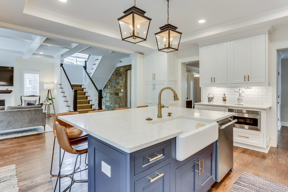 Inspiration for a large transitional medium tone wood floor kitchen remodel in DC Metro with a farmhouse sink, beaded inset cabinets, quartz countertops, stainless steel appliances and an island