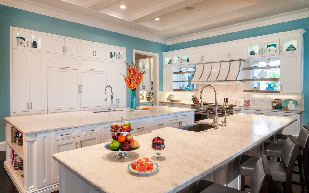 Trendy galley kitchen photo in Miami with marble countertops, white backsplash, stone tile backsplash and two islands