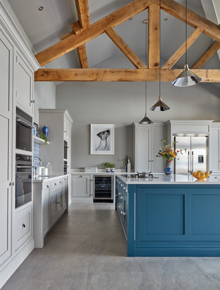 Inspiration for an expansive classic l-shaped open plan kitchen in Other with an integrated sink, shaker cabinets, grey cabinets, quartz worktops, blue splashback, stone tiled splashback, stainless steel appliances, porcelain flooring, an island, grey floors and white worktops.