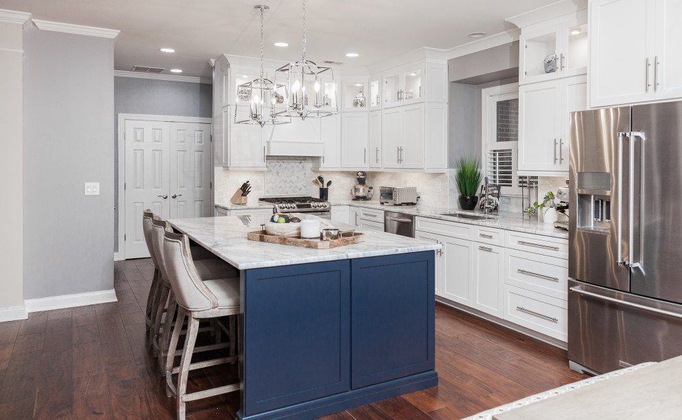 Eat-in kitchen - huge traditional medium tone wood floor eat-in kitchen idea in Atlanta with a double-bowl sink, shaker cabinets, blue cabinets, quartzite countertops, white backsplash, marble backsplash, stainless steel appliances, an island and white countertops