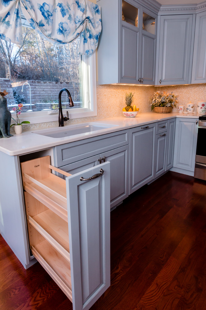 Inspiration for a mid-sized timeless u-shaped dark wood floor eat-in kitchen remodel in Minneapolis with an undermount sink, raised-panel cabinets, blue cabinets, quartz countertops, yellow backsplash, mosaic tile backsplash, stainless steel appliances and no island