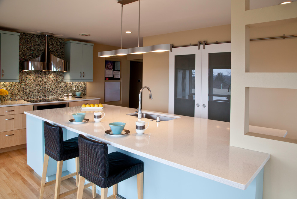 Example of a large trendy u-shaped light wood floor and brown floor eat-in kitchen design in Other with an undermount sink, flat-panel cabinets, blue cabinets, quartz countertops, multicolored backsplash, mosaic tile backsplash, stainless steel appliances and an island