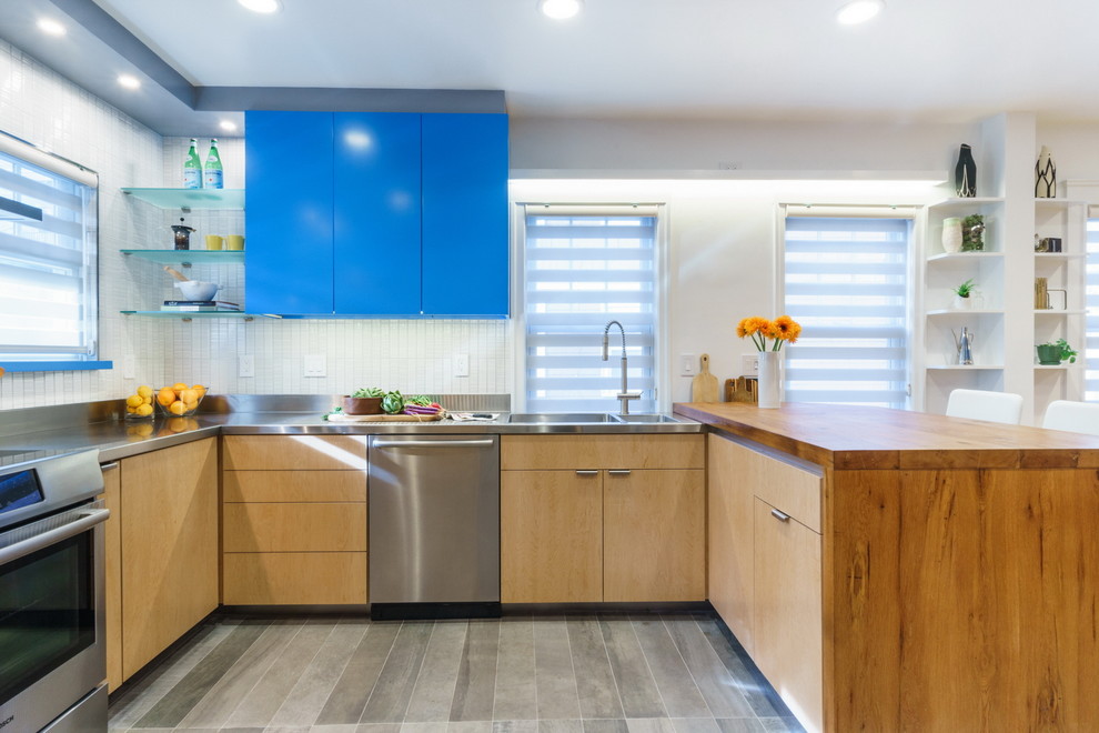 Inspiration for a mid-sized u-shaped porcelain tile eat-in kitchen remodel in Boston with an integrated sink, flat-panel cabinets, light wood cabinets, wood countertops, white backsplash, ceramic backsplash, stainless steel appliances and an island
