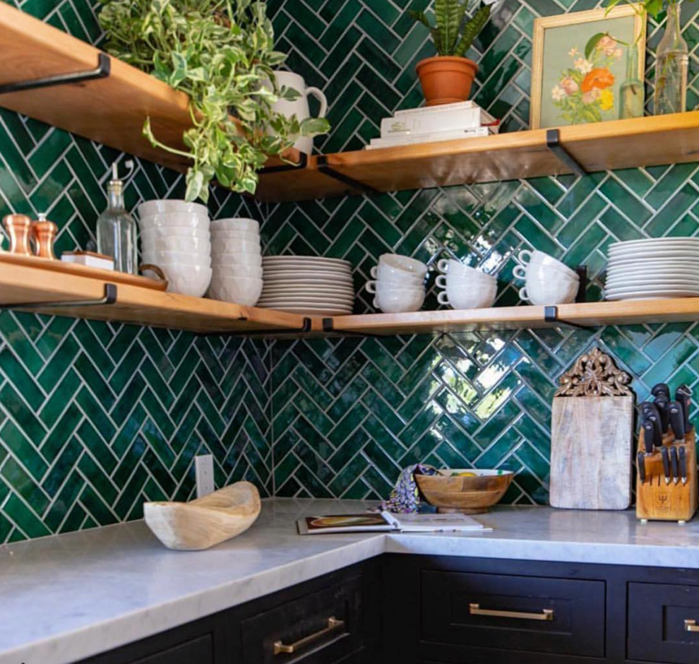 Inspiration for an u-shaped kitchen in Minneapolis with black cabinets, green splashback, ceramic splashback, an island, beige floors and white worktops.