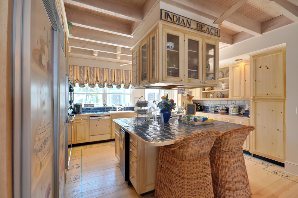 Large beach style l-shaped light wood floor kitchen pantry photo in Other with a drop-in sink, recessed-panel cabinets, light wood cabinets, tile countertops, blue backsplash, terra-cotta backsplash, paneled appliances and two islands