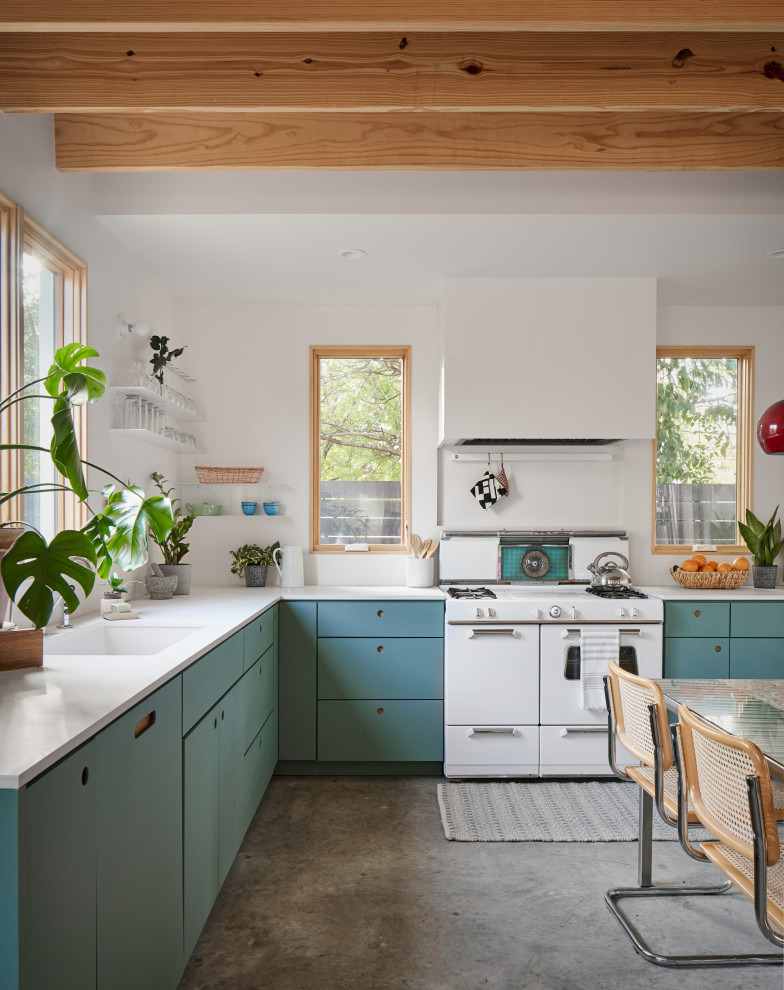 Design ideas for a medium sized eclectic l-shaped kitchen in Austin with a submerged sink, flat-panel cabinets, green cabinets, engineered stone countertops, white appliances, concrete flooring, no island, grey floors and white worktops.