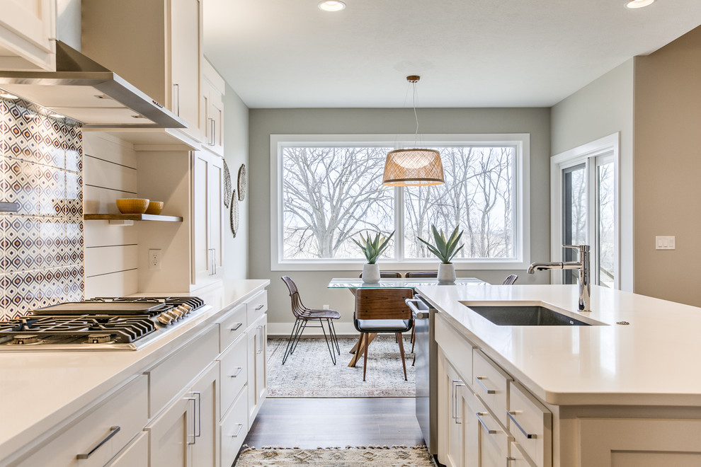Photo of a scandinavian open plan kitchen in Omaha with a submerged sink, shaker cabinets, engineered stone countertops, stainless steel appliances, an island and white worktops.