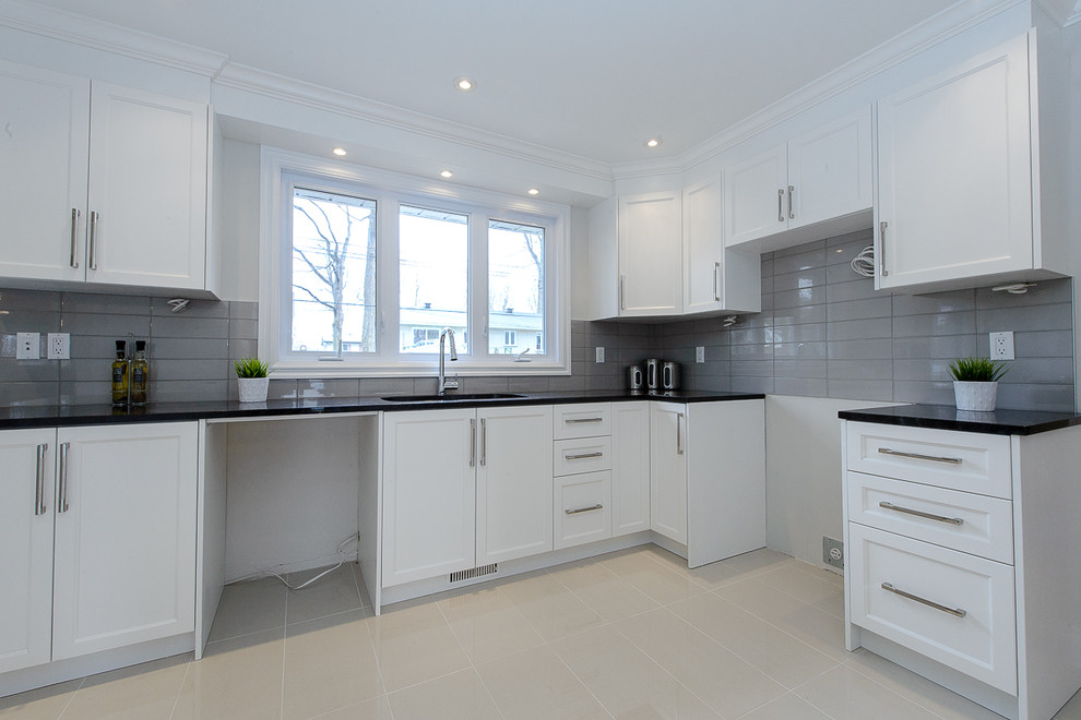 Inspiration for a small modern l-shaped enclosed kitchen in Montreal with a submerged sink, shaker cabinets, white cabinets, granite worktops, grey splashback, ceramic splashback and porcelain flooring.
