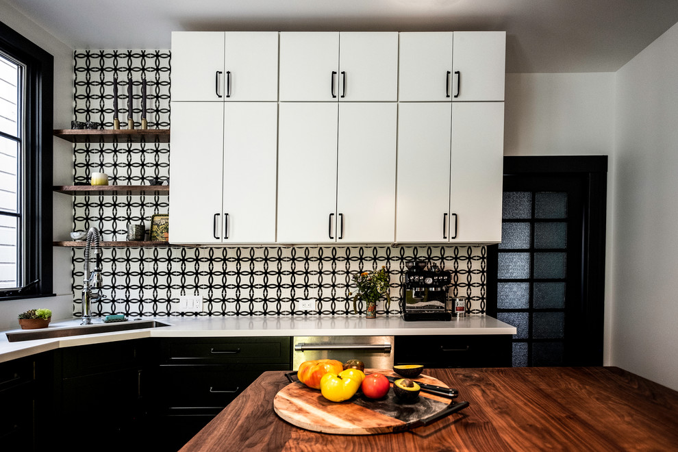 Medium sized bohemian u-shaped enclosed kitchen in San Francisco with black cabinets, composite countertops, an island, white worktops, a submerged sink, recessed-panel cabinets, multi-coloured splashback, ceramic splashback, stainless steel appliances, dark hardwood flooring and brown floors.