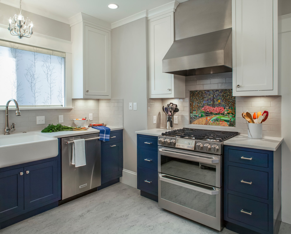 Example of a transitional gray floor kitchen design in Portland with a farmhouse sink, shaker cabinets, blue cabinets, gray backsplash, subway tile backsplash, stainless steel appliances, no island and gray countertops