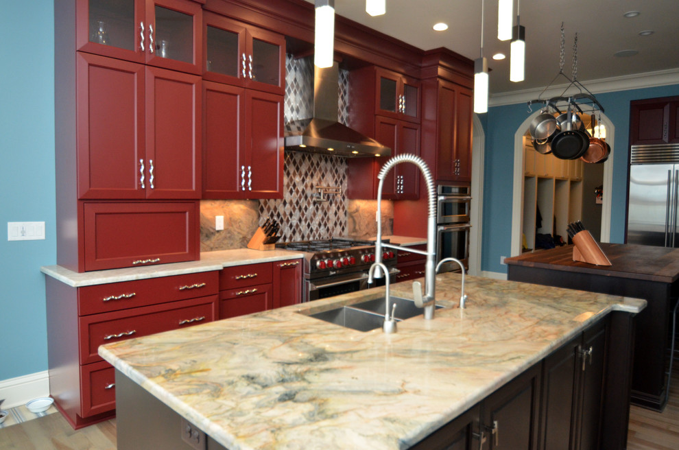 Inspiration for a large transitional l-shaped kitchen remodel in New York with a double-bowl sink, red cabinets, quartzite countertops, stainless steel appliances, two islands, recessed-panel cabinets, gray backsplash and stone slab backsplash