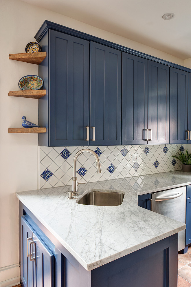 Inspiration for a small mediterranean galley terra-cotta tile and orange floor eat-in kitchen remodel in Philadelphia with a single-bowl sink, shaker cabinets, blue cabinets, marble countertops, blue backsplash, ceramic backsplash, stainless steel appliances and no island