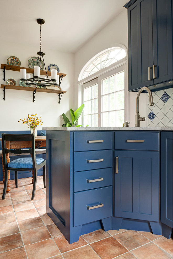 Example of a small tuscan galley terra-cotta tile and orange floor eat-in kitchen design in Philadelphia with a single-bowl sink, shaker cabinets, blue cabinets, marble countertops, blue backsplash, ceramic backsplash, stainless steel appliances and no island