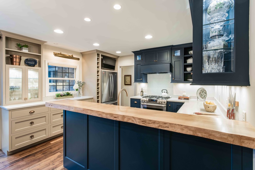 Example of a small classic u-shaped dark wood floor eat-in kitchen design in Minneapolis with an undermount sink, beaded inset cabinets, blue cabinets, quartz countertops, stainless steel appliances, a peninsula and white countertops