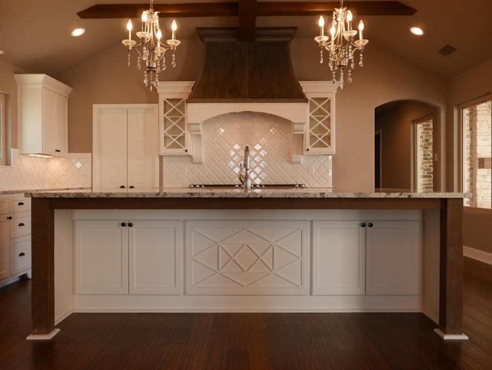 Inspiration for a large timeless l-shaped vinyl floor eat-in kitchen remodel in Austin with a farmhouse sink, shaker cabinets, white cabinets, granite countertops, white backsplash, porcelain backsplash, stainless steel appliances and an island