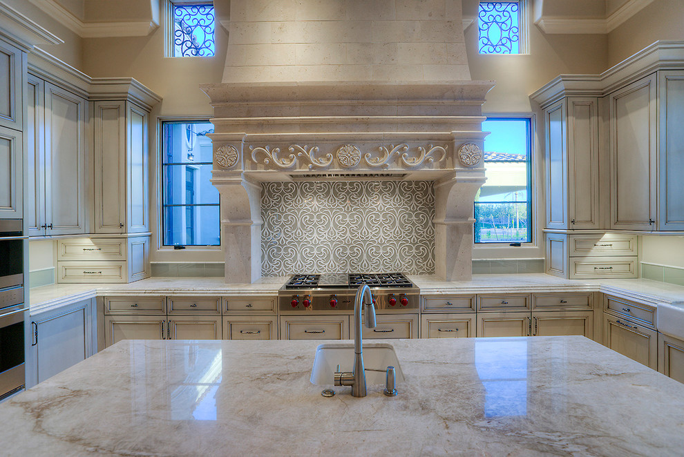 Huge tuscan u-shaped porcelain tile and beige floor open concept kitchen photo in Phoenix with an undermount sink, recessed-panel cabinets, light wood cabinets, quartzite countertops, multicolored backsplash, porcelain backsplash, stainless steel appliances, two islands and beige countertops