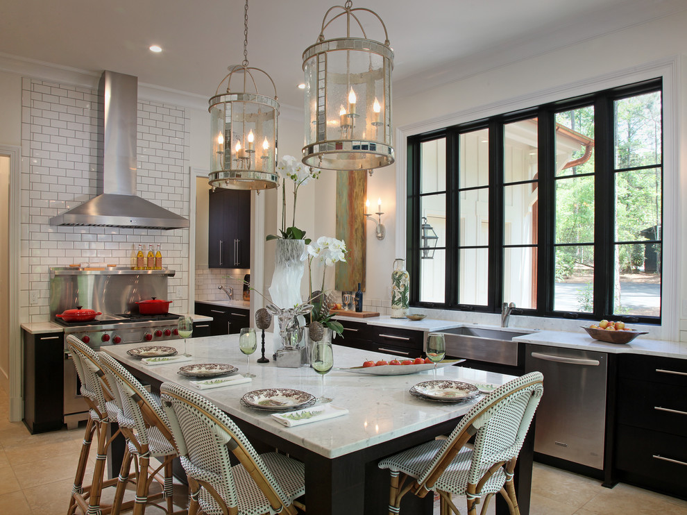 Example of a mid-sized transitional l-shaped ceramic tile eat-in kitchen design in Atlanta with a farmhouse sink, marble countertops, white backsplash, subway tile backsplash, stainless steel appliances, an island, flat-panel cabinets and dark wood cabinets