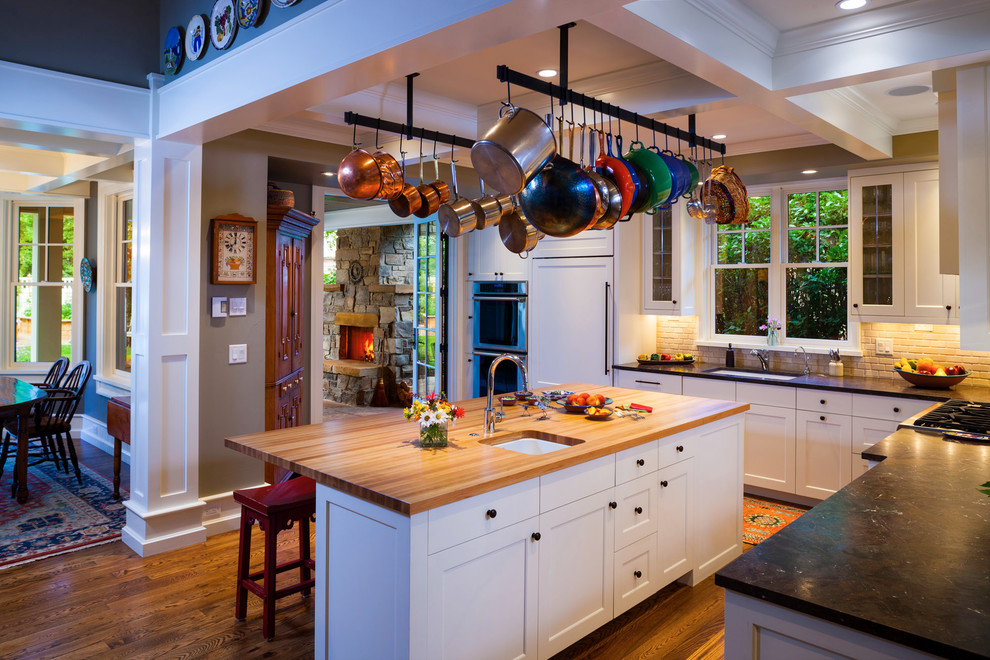 Kitchen - traditional l-shaped kitchen idea in Other with shaker cabinets, white cabinets, wood countertops and paneled appliances
