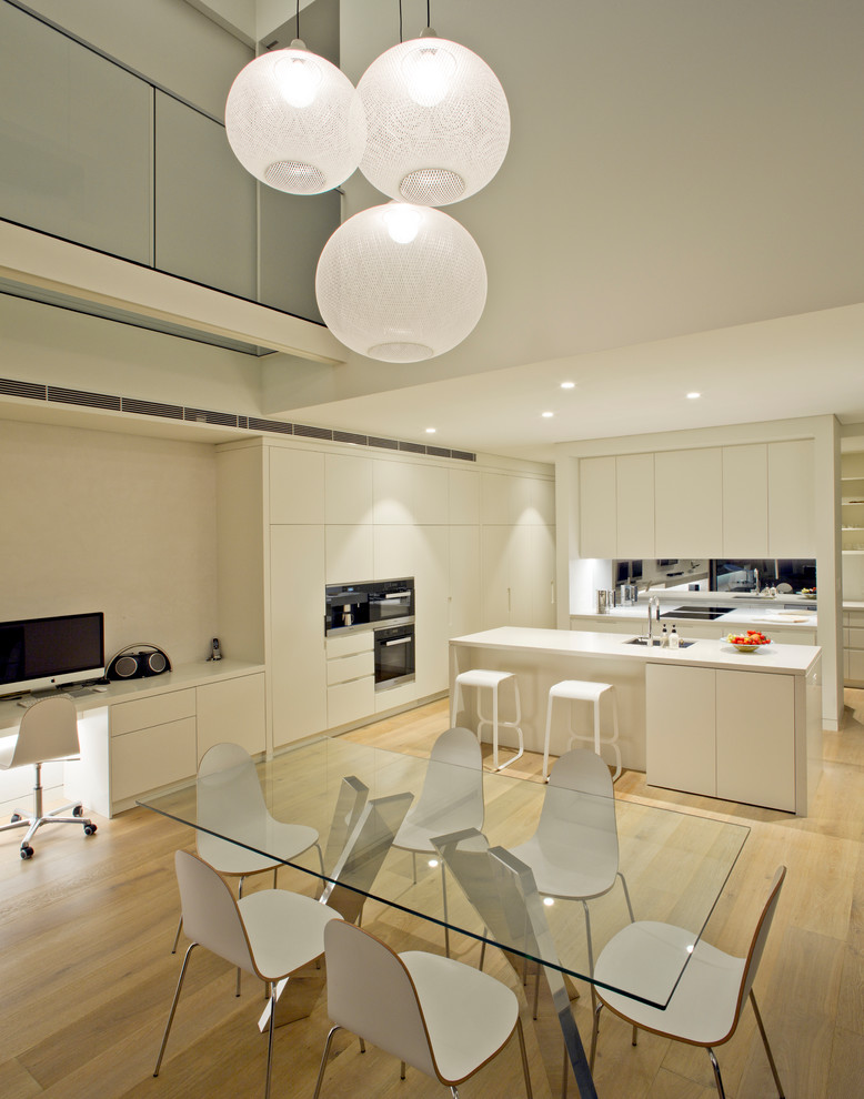 Große Moderne Wohnküche in L-Form mit weißen Schränken und Kücheninsel in Sydney