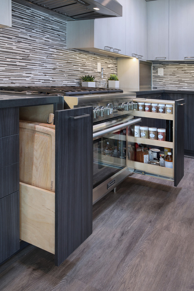 Inspiration for a mid-sized contemporary gray floor and laminate floor kitchen pantry remodel in Orange County with flat-panel cabinets, gray cabinets, porcelain backsplash, stainless steel appliances, an island, an undermount sink, quartz countertops and multicolored backsplash