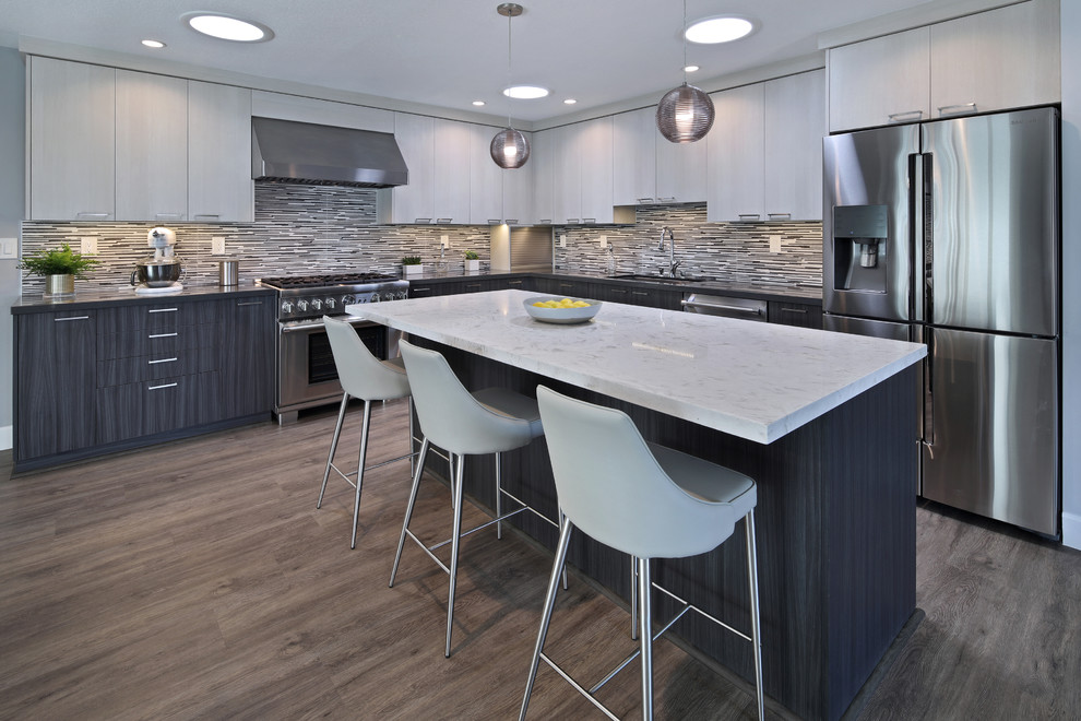 Inspiration for a mid-sized contemporary l-shaped gray floor and laminate floor eat-in kitchen remodel in Orange County with flat-panel cabinets, porcelain backsplash, stainless steel appliances, an island, an undermount sink, dark wood cabinets, quartz countertops and multicolored backsplash