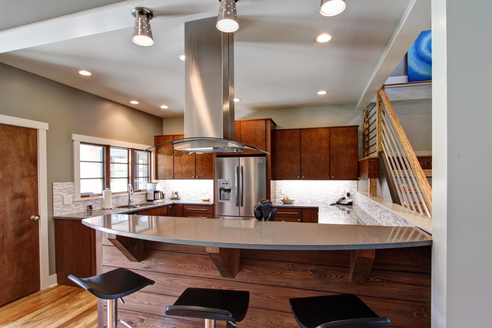 Inspiration for a contemporary open plan kitchen in Other with flat-panel cabinets, dark wood cabinets, stainless steel appliances, a submerged sink, medium hardwood flooring and a breakfast bar.