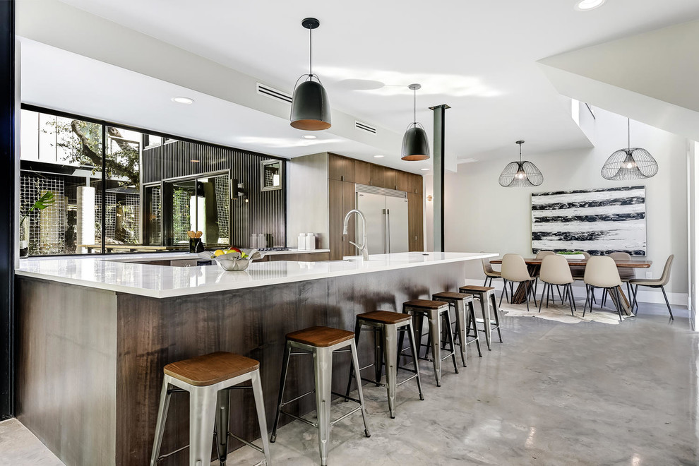 Design ideas for a contemporary u-shaped kitchen/diner in Austin with flat-panel cabinets, medium wood cabinets, window splashback, stainless steel appliances, a breakfast bar and grey floors.