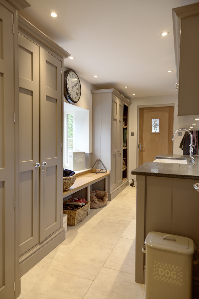 This is an example of a medium sized traditional kitchen in Hampshire with flat-panel cabinets, grey cabinets and limestone flooring.