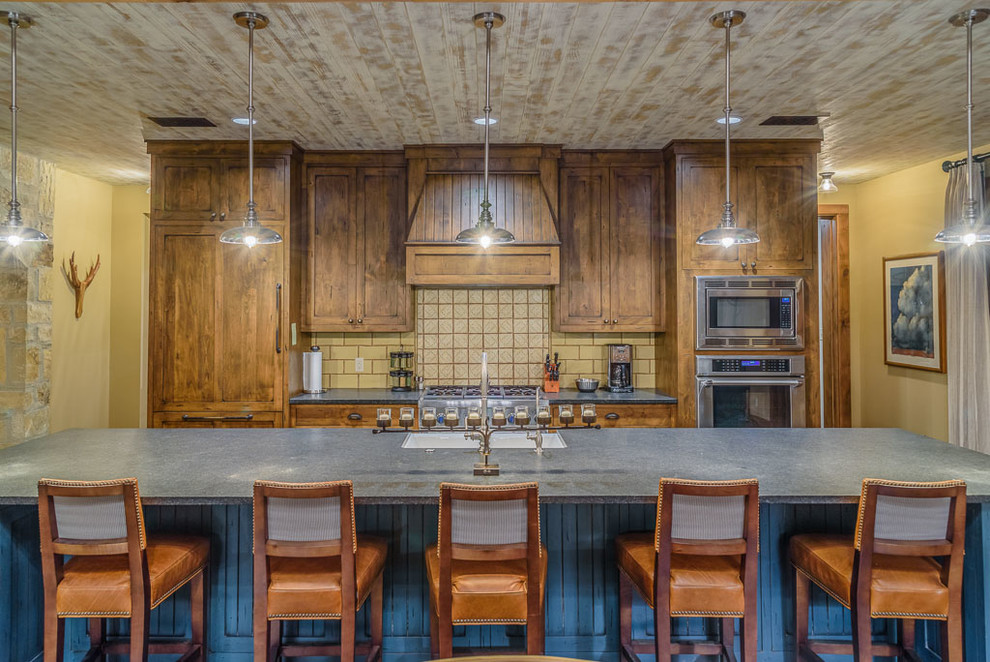 Inspiration for a rustic galley kitchen in Austin with a single-bowl sink, shaker cabinets, distressed cabinets, yellow splashback, integrated appliances and a breakfast bar.