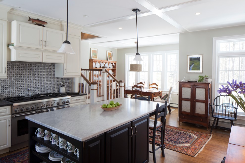 Inspiration for a mid-sized farmhouse l-shaped medium tone wood floor open concept kitchen remodel in Portland Maine with raised-panel cabinets, white cabinets, marble countertops, glass tile backsplash, stainless steel appliances, an island and a farmhouse sink