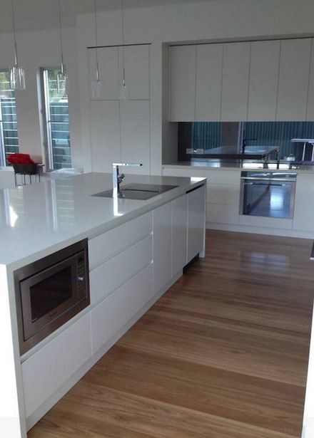 Trendy l-shaped eat-in kitchen photo in Sydney with an undermount sink, flat-panel cabinets, white cabinets, quartz countertops and stainless steel appliances