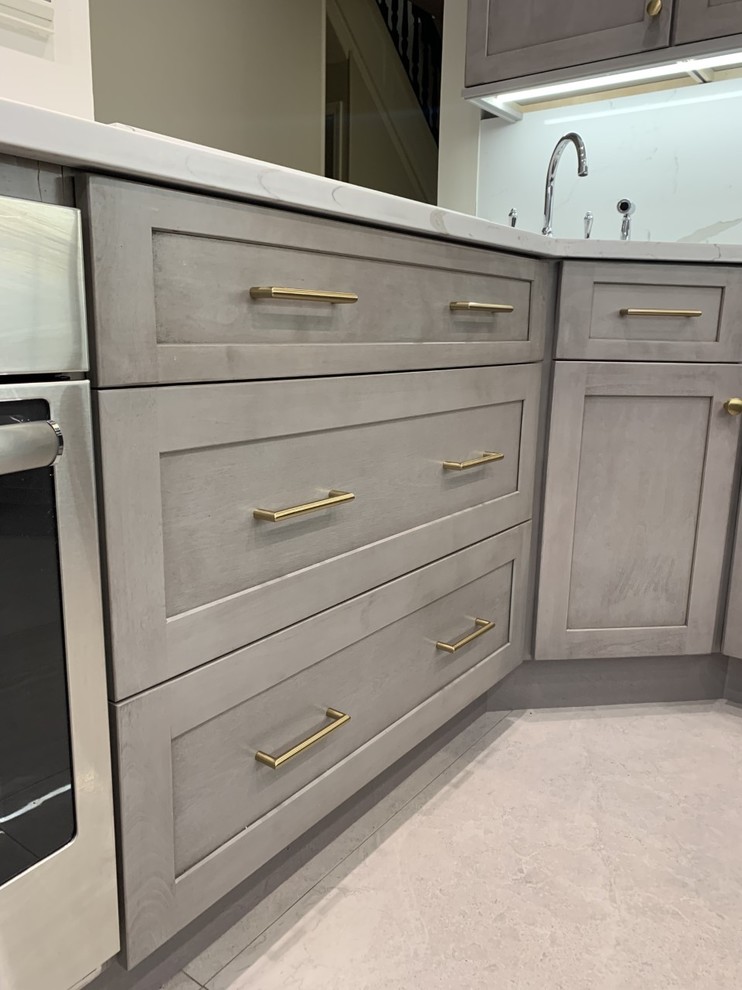 Contemporary kitchen in New York with shaker cabinets, light wood cabinets, marble worktops, multi-coloured splashback, marble splashback and multicoloured worktops.