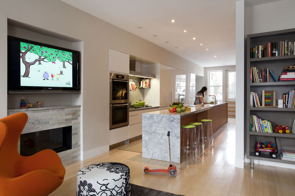 Eat-in kitchen - contemporary galley eat-in kitchen idea in Boston with flat-panel cabinets, marble countertops, stainless steel appliances and an island