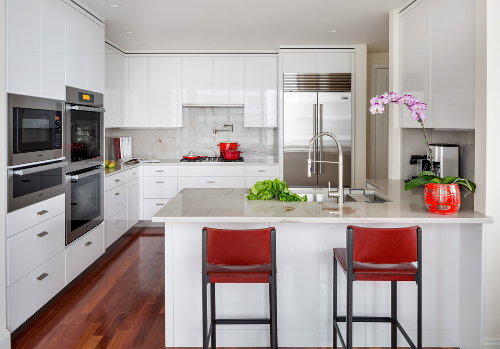 Inspiration for a small contemporary u-shaped dark wood floor eat-in kitchen remodel in Boston with flat-panel cabinets, white cabinets, quartzite countertops, white backsplash, stainless steel appliances, an undermount sink, stone slab backsplash and no island