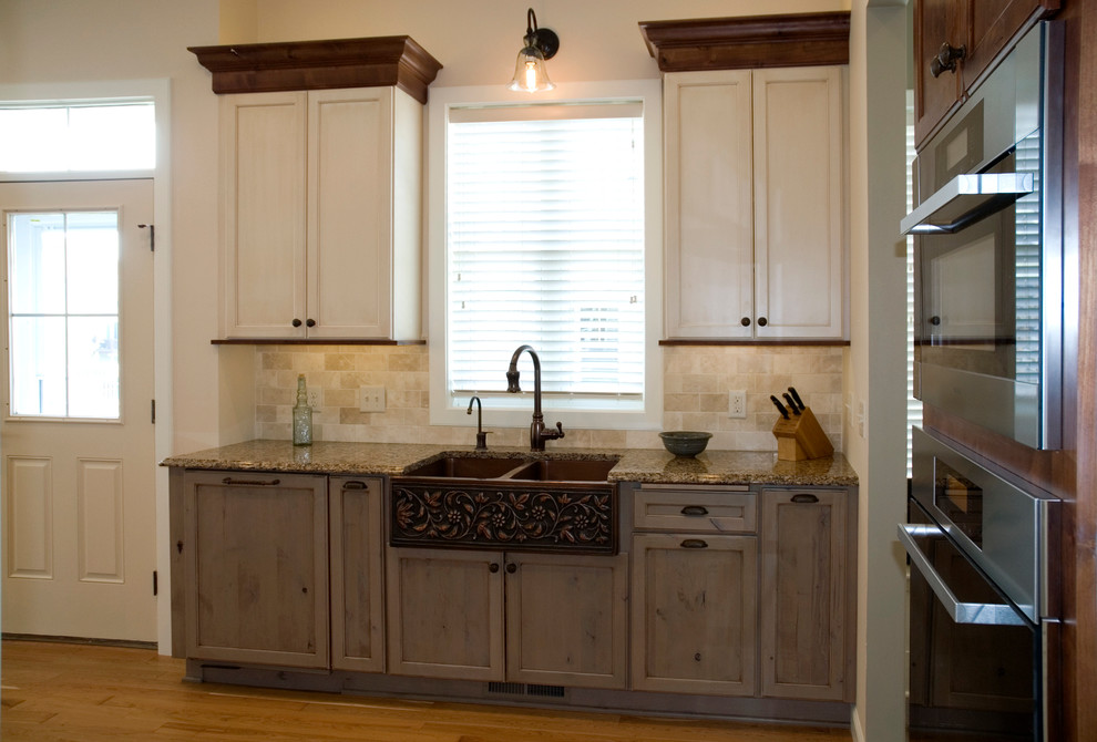 Inspiration for a large cottage l-shaped medium tone wood floor open concept kitchen remodel in Minneapolis with a farmhouse sink, recessed-panel cabinets, gray cabinets, quartz countertops, beige backsplash, stone tile backsplash and stainless steel appliances