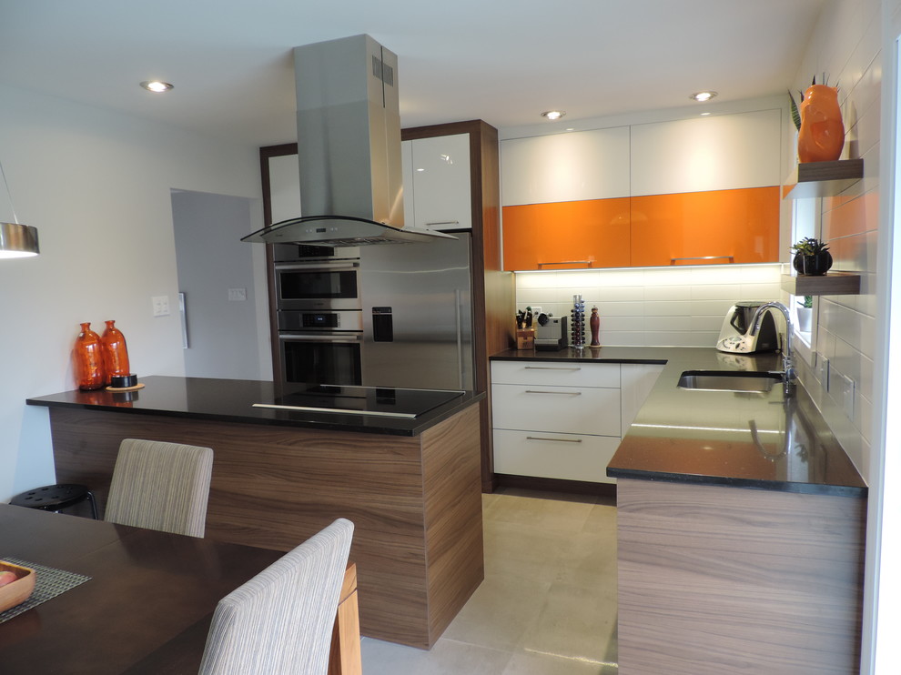 This is an example of a medium sized contemporary u-shaped kitchen/diner in Montreal with a double-bowl sink, flat-panel cabinets, medium wood cabinets, quartz worktops, white splashback, ceramic splashback, stainless steel appliances, concrete flooring and an island.
