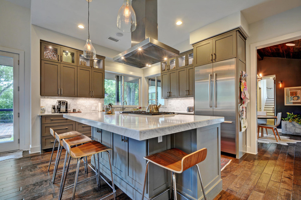 Design ideas for a classic l-shaped kitchen in Austin with shaker cabinets, grey cabinets, marble worktops, grey splashback, stainless steel appliances, medium hardwood flooring and an island.