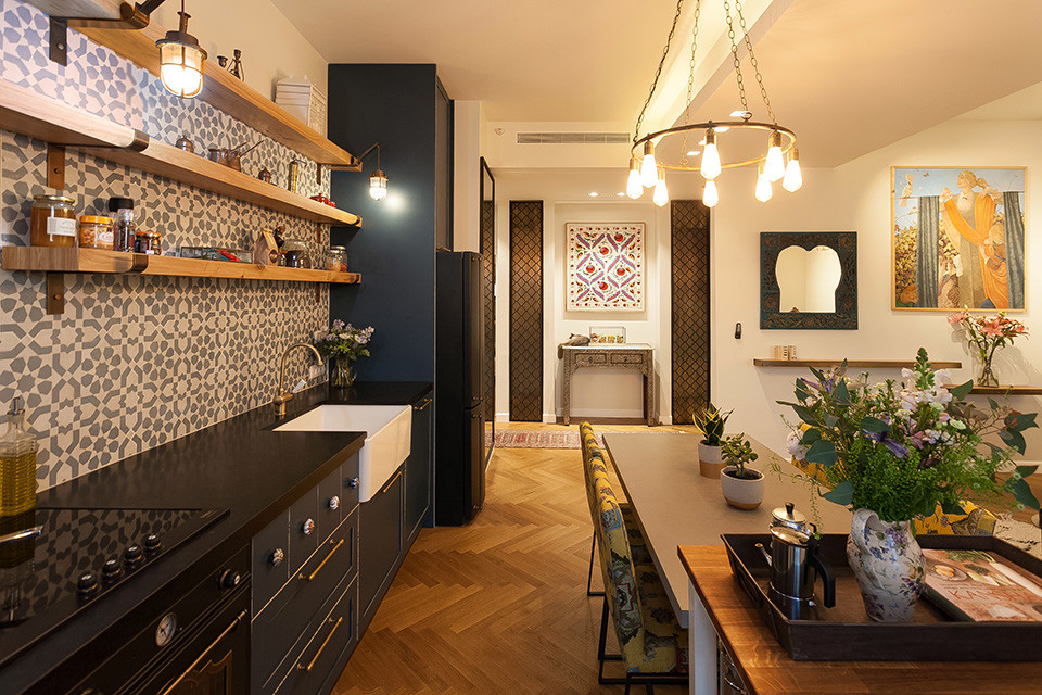 Foto på ett eklektiskt linjärt kök och matrum, med blå skåp, granitbänkskiva, blått stänkskydd, stänkskydd i mosaik, ljust trägolv och en köksö