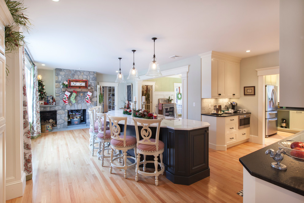 На фото: п-образная кухня-гостиная среднего размера в классическом стиле с фасадами в стиле шейкер, белыми фасадами, мраморной столешницей, светлым паркетным полом и островом