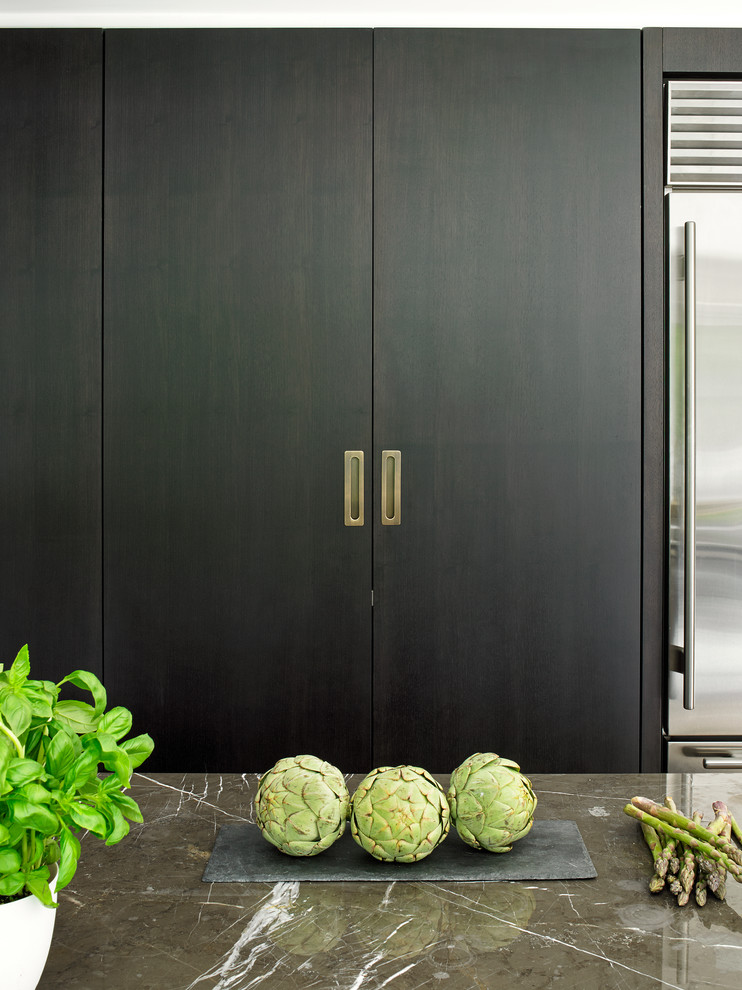 Inspiration for a contemporary kitchen in London with flat-panel cabinets and black cabinets.